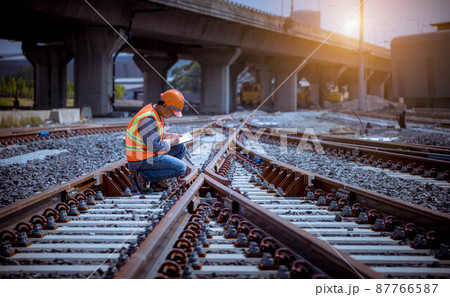 Engineer under discussion inspection and checking construction process railway switch and checking work on railroad station .Engineer wearing safety uniform and safety helmet in work. Engineer under discussion inspection and checking construction process railway switch and checking work on railroad station .Engineer wearing safety uniform and safety helmet in work. 87766587
