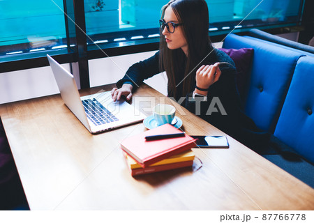 Serious woman surfing laptop while working Serious woman surfing laptop while working 87766778