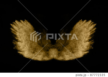 Golden powder explosion on black background. Freeze motion. Golden powder explosion on black background. Freeze motion. 87772335