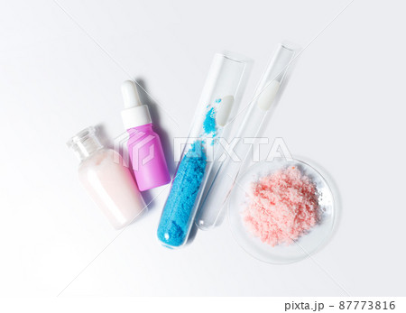 Beauty care cream, serum, Copper(II) sulfate in test tube and himalayan pink salt. Chemicals for beauty care on white laboratory table. (Top View) 87773816