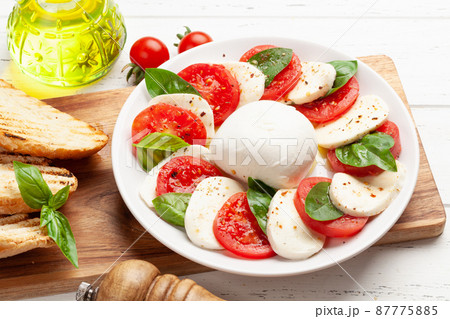Caprese salad with mozzarella, basil and garden tomatoes Caprese salad with mozzarella, basil and garden tomatoes 87775885