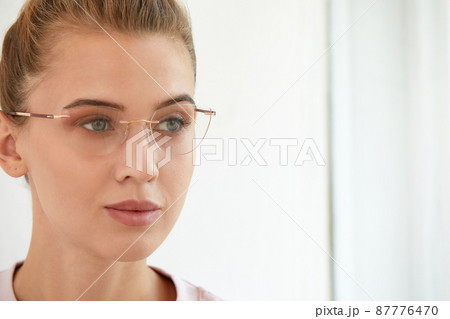 Close-up shot of smiling attractive happy and successful european blond female in sweater watch and glasses grinning expressing confidence, looking accomlished and daring at camera with sassy smile. Close-up shot of smiling attractive happy and successful european blond female in sweater watch and glasses grinning expressing confidence, looking accomlished and daring at camera with sassy smile. 87776470