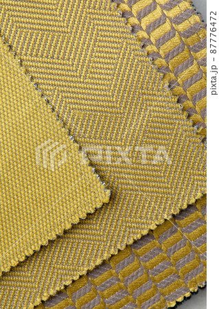 The background consists of several types of colored tiles with different patterns on golden tone The background consists of several types of colored tiles with different patterns on golden tone 87776472