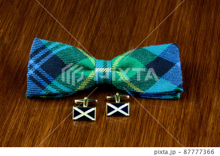 Tartan Bow Tie and Scottish Saltire Cuff Links on a Wooden Table Tartan Bow Tie and Scottish Saltire Cuff Links on a Wooden Table 87777366