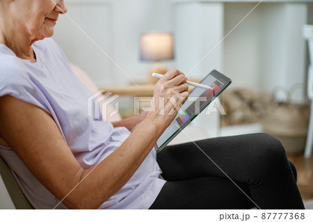female designer with a tablet working on a new project. 87777368