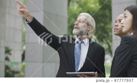 caucasian businessman pointing upward with finger caucasian businessman pointing upward with finger 87777937