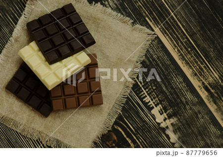 Assorted chocolate on rustic wooden background. 87779656