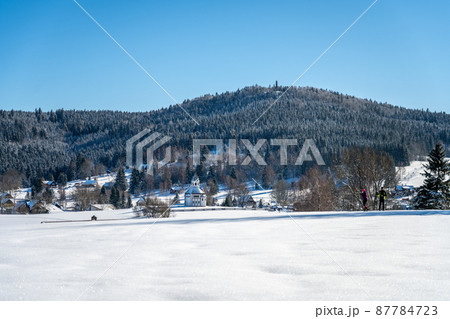 Wooden chapel and Stepanka lookout tower on background in wintertime 87784723