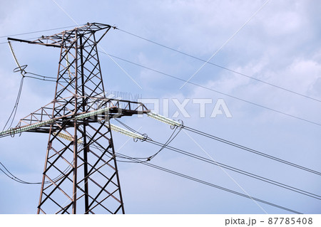 Steel pillar with high voltage electric power lines delivering electrical energy through cable wires on long distance Steel pillar with high voltage electric power lines delivering electrical energy through cable wires on long distance 87785408