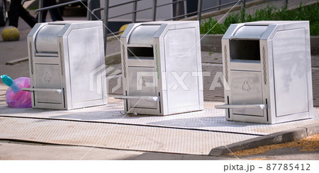 Stainless steel garbage cans for separate disposal of recycle trash on city street Stainless steel garbage cans for separate disposal of recycle trash on city street 87785412