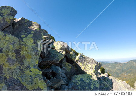 Rocky mountain hillside with big stone boulders on sunny day Rocky mountain hillside with big stone boulders on sunny day 87785482