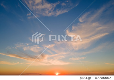 Bright colorful sunset sky with rays of setting sun and vivid dark clouds 87786062