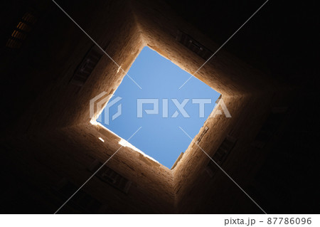 Square light window in dark tower interior Square light window in dark tower interior 87786096
