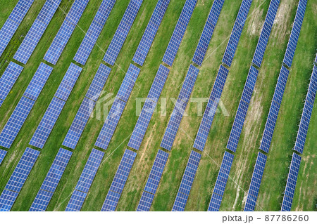 Aerial view of big sustainable electric power plant with many rows of solar photovoltaic panels for producing clean ecological electrical energy. Renewable electricity with zero emission concept 87786260