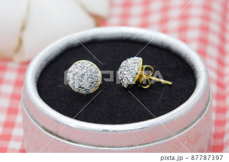Beautiful golden earrings decorated with diamond display in jewelry box 87787397
