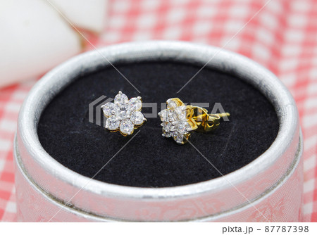 Beautiful diamond earrings in flower shape display in jewelry box 87787398