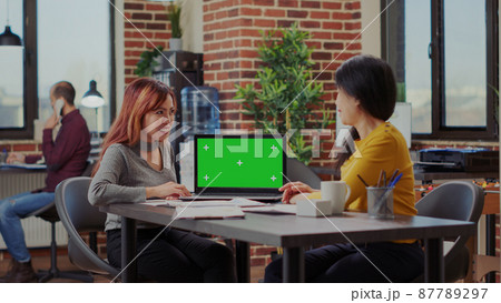 Asian women analyzing green screen on computer in office 87789297