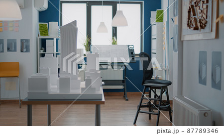 Empty technical office with real estate construction plan and building model on desk 87789346