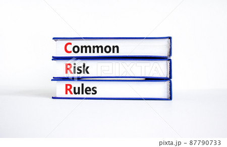 CRR common risk rules symbol. Concept words CRR common risk rules on books on a beautiful white table, white background. Business and CRR common risk rules concept. Copy space. 87790733