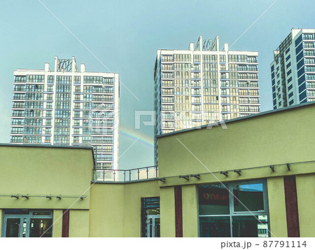 a new area of the city with high glass houses. new buildings with glass windows and doors. next to a shopping center painted yellow a new area of the city with high glass houses. new buildings with glass windows and doors. next to a shopping center painted yellow 87791114