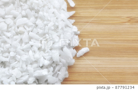 Close up picture of coconut shreds on a wooden background, selective focus. Close up picture of coconut shreds on a wooden background, selective focus. 87791234