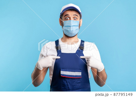 Wow this is me. Surprised handyman in overalls, mask pointing himself, shocked and proud of achievement. Profession of service industry, courier delivery, housekeeping maintenance. indoor, isolated 87795149