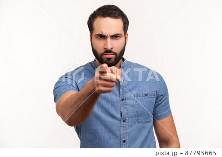 Serious bossy bearded man pointing finger at camera choosing you, scolding and forcing to move on. Indoor studio shot isolated on white background 87795665