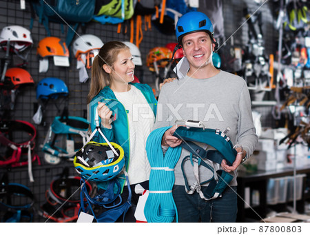 Portrait of young couple choosing sports equipment Portrait of young couple choosing sports equipment 87800803