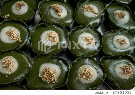 Thai Dessert Pandan Sweet Pudding (Kanom Piak Poon Bai Toey) in Sweet Coconut milk Cream with sesame seeds and Thai pudding with coconut topping. 87801055
