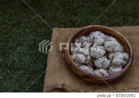 Thai Shortbread Cookies (Thai Dessert), Kanom Kleeb Lum Duen on burlap fabric background. Thai Shortbread Cookies (Thai Dessert), Kanom Kleeb Lum Duen on burlap fabric background. 87801092