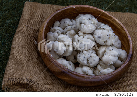 Thai Shortbread Cookies (Thai Dessert), Kanom Kleeb Lum Duen on burlap fabric background. Thai Shortbread Cookies (Thai Dessert), Kanom Kleeb Lum Duen on burlap fabric background. 87801128
