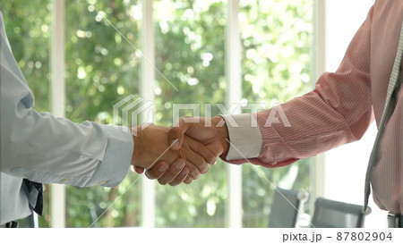 Team Business Partners shaking hands together to Greeting Start up small business in meeting room. Shakehand teamwork partners at modern office handshake together. Business mergers and acquisitions 87802904