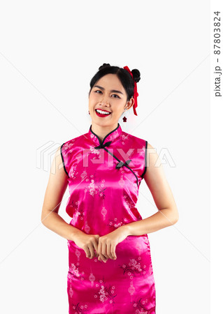 Chinese new year woman concept, Asian woman smiling and wearing pink Cheongsam dress isolated on white background. 87803824
