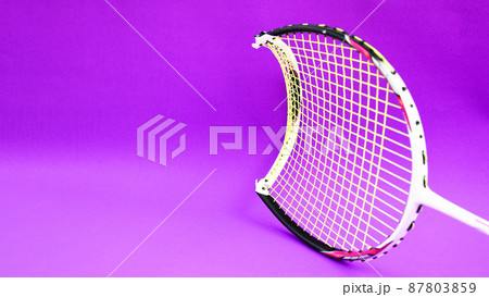 Unused badminton shuttlecocks and broken string racket on the floor of indoor badminton court, concept for badminton lovers around the world. 87803859