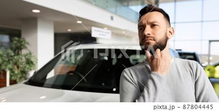 a man thought about buying a new car, a car from a car dealer on credit a man thought about buying a new car, a car from a car dealer on credit 87804445