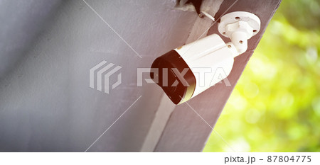 Mini cctv cameras installed on ceiling outside the house to record and to do security at home when the house owner stayed outside, soft and selective focus on cctv cameras. Mini cctv cameras installed on ceiling outside the house to record and to do security at home when the house owner stayed outside, soft and selective focus on cctv cameras. 87804775
