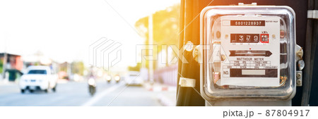 Electricity meters for household users are mounted on high-voltage pole by the side of the road. Electricity meters for household users are mounted on high-voltage pole by the side of the road. 87804917