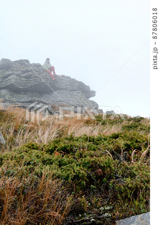 The tourist is lying on a rock near Mount Petros The tourist is lying on a rock near Mount Petros 87806018