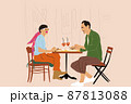 Couple sitting together at restaurant terrace on the city street 87813088