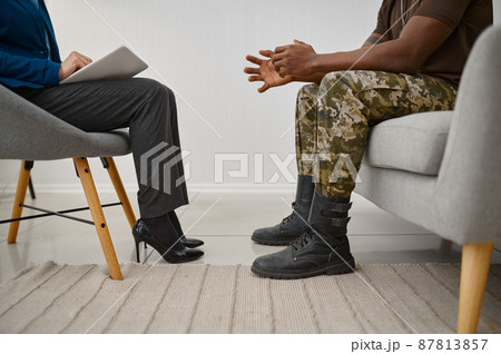 Military male patient sitting front of psychologist Military male patient sitting front of psychologist 87813857