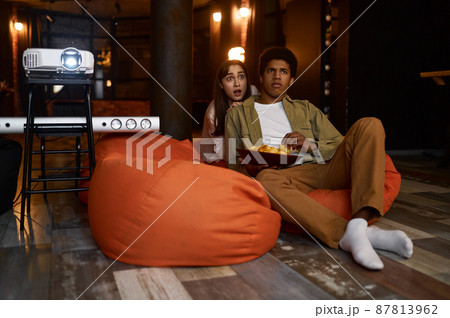 Young couple watch movie film on projector 87813962
