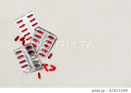 Protective face masks or surgical masks, medicine pills and thermometer on table background. Coronavirus disease. Corona virus concept. Space for text 87815399