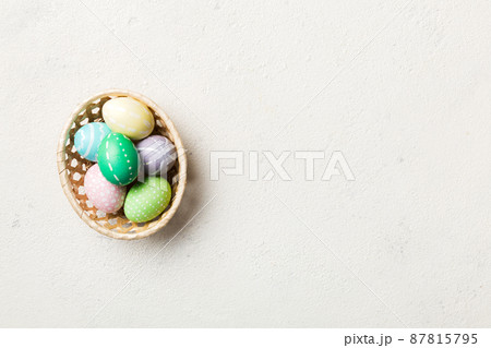 Multi colors Easter eggs in the woven basket onの写真素材
