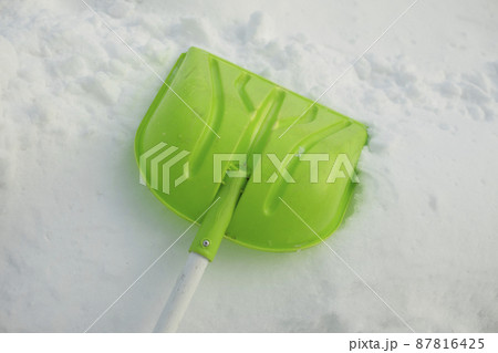 Shovel for snow. Green shovel for clearing path from snow. Shovel for snow. Green shovel for clearing path from snow. 87816425