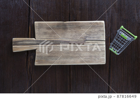 Empty cutting board on wooden brown background Empty cutting board on wooden brown background 87816649