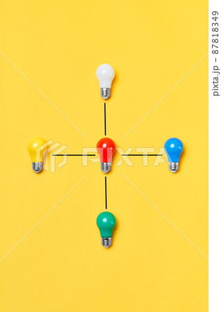 Creative layout with multicolored lightbulbs on yellow background. 87818349