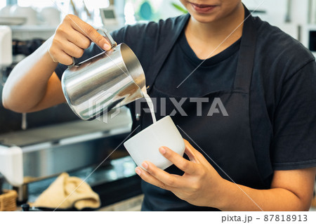 woman barista wear apron uniform making coffee in cafe counter serve for customer. woman barista wear apron uniform making coffee in cafe counter serve for customer. 87818913