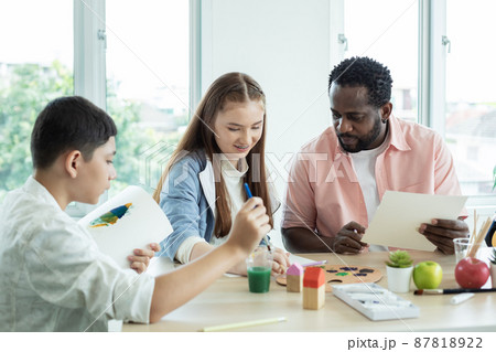 Girl and boy with teacher in art classroom. group student learning art subject. Girl and boy with teacher in art classroom. group student learning art subject. 87818922