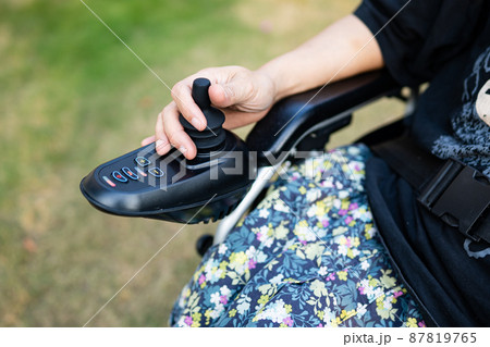 Asian lady woman patient on electric wheelchair with joystick and remote control at nursing hospital ward, healthy strong medical concept 87819765