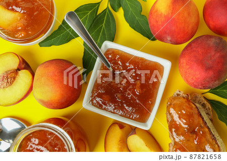 Peach jam and ingredients on yellow background Peach jam and ingredients on yellow background 87821658